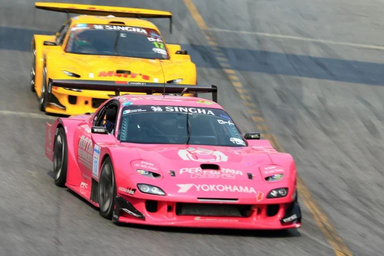 Two race cars at speed on the track