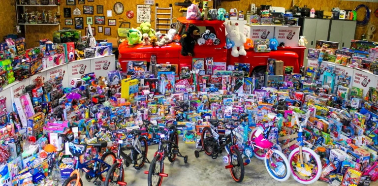Rows of donated toys and bikes in front of a red pickup